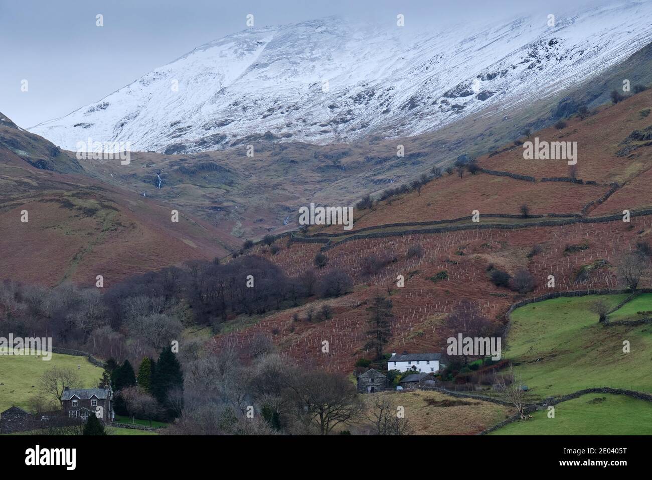 Cottages near Mill Bridge under a snowy Fairfield, near Grasmere, Lake District, Cumbria Stock Photo