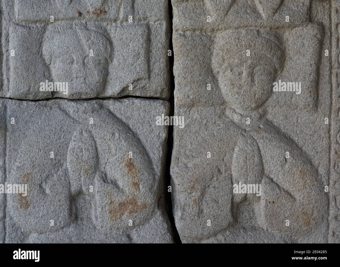 Tombstone with relief depicting two praying figures. 1400-1450. The upper part shows the marriage formed by Gomez Patiño and Maria de Galo to whom the tombstone belongs. Detail of the lower part, their twin daughters. From the Convent of Santo Domingo (La Coruña, Galicia, Spain). Archaeological and History Museum of A Coruña (San Anton Castle). Galicia, Spain. Stock Photo