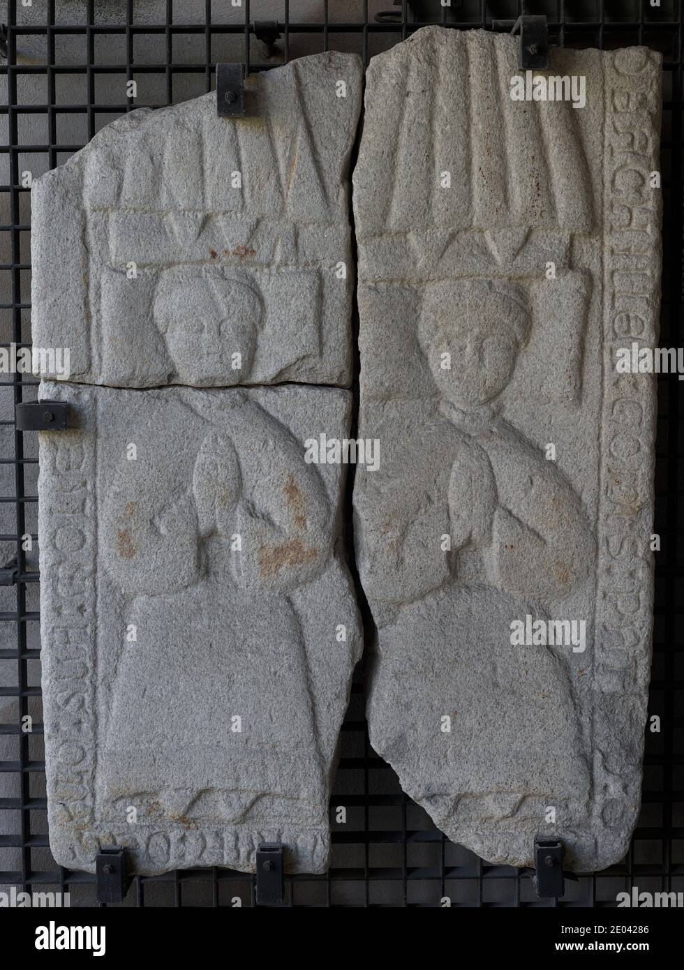 Tombstone with relief depicting two praying figures. 1400-1450. The upper part shows the marriage formed by Gomez Patiño and Maria de Galo to whom the tombstone belongs. In the lower part, their twin daughters. From the Convent of Santo Domingo (La Coruña, Galicia, Spain). Archaeological and History Museum of A Coruña (San Anton Castle). Galicia, Spain. Stock Photo