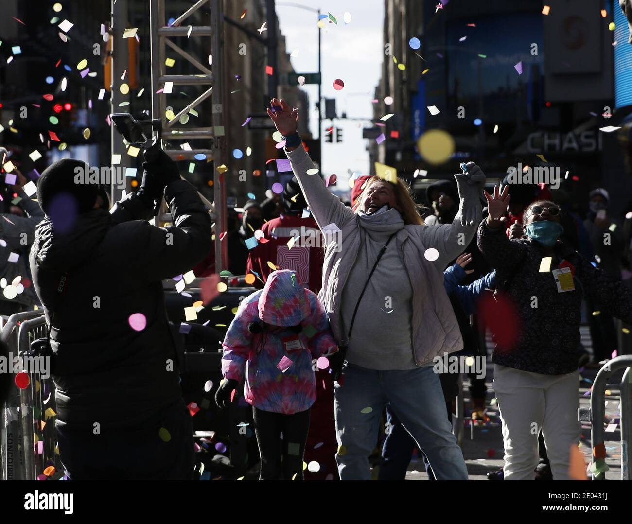 New York, United States. 29th Dec, 2020. Revelers react as confetti falls from the Hard Rock Cafe marquee as part of the annual New Year's Eve Confetti Test in Times Square in New York City on Tuesday, December 29, 2020. Due to the ongoing COVID-19 pandemic, New Years Eve 2021 in Times Square will not be open to the public this year. Photo by John Angelillo/UPI Credit: UPI/Alamy Live News Stock Photo