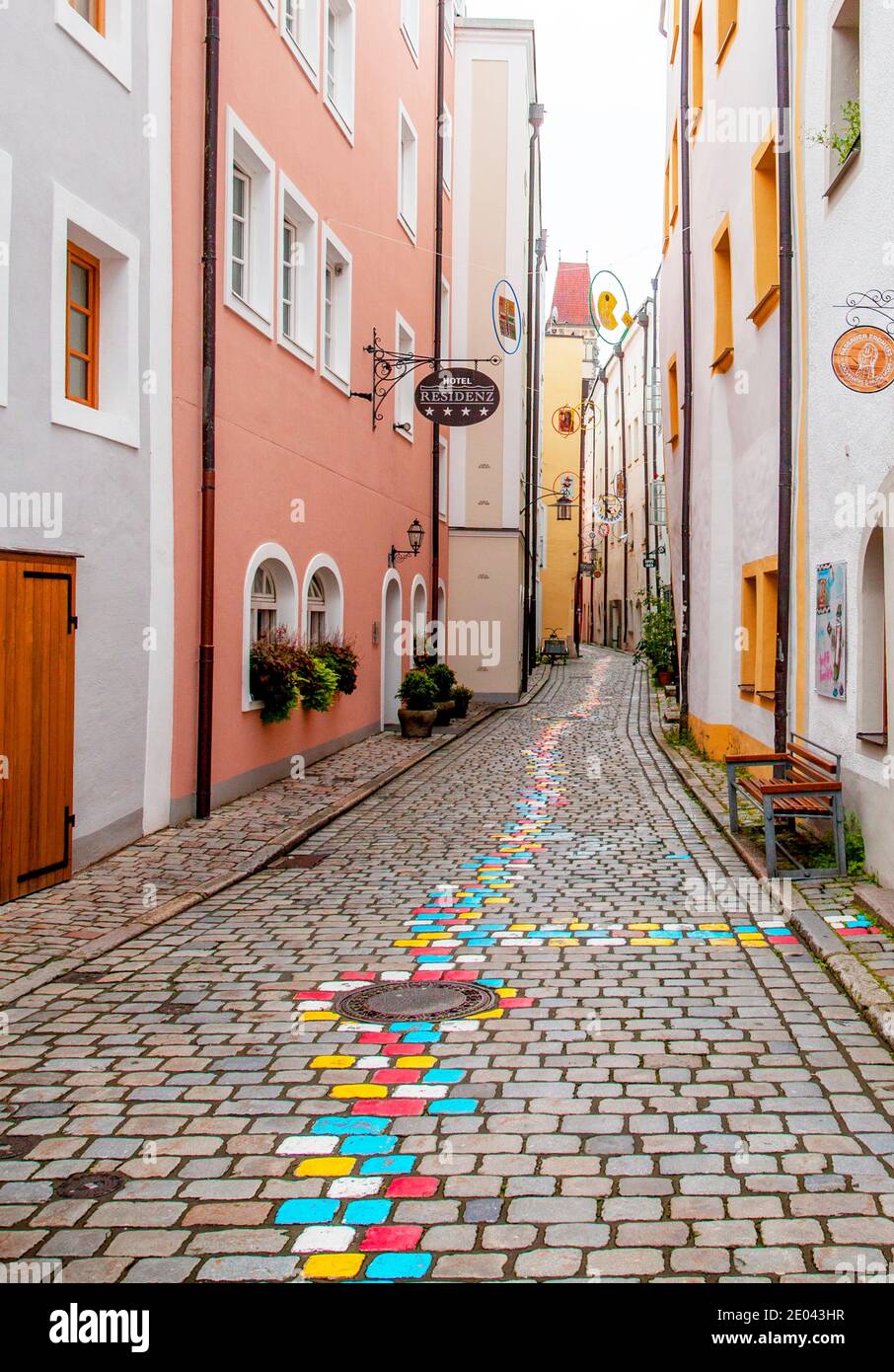 This narrow lane, one block up from the Danube River, offers painted stones to direct people to various artists' workshops in Passau, Bavaria, Germany Stock Photo