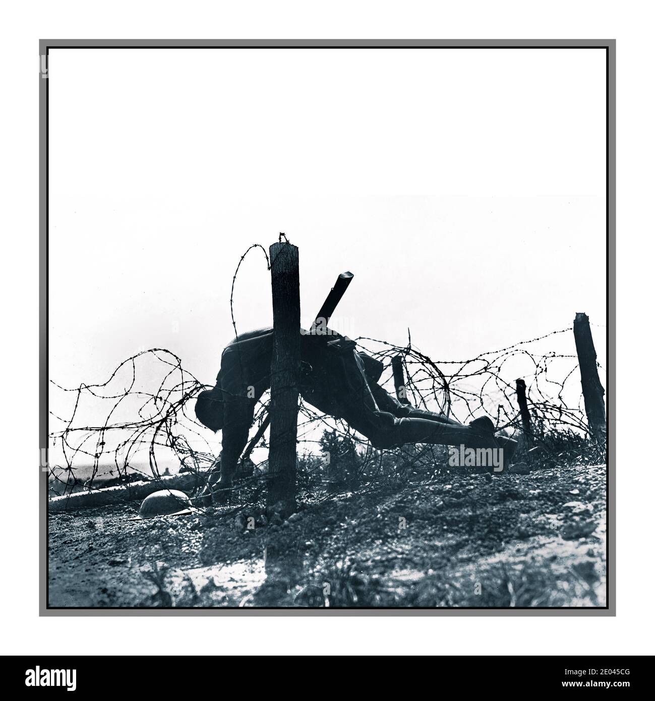 WW1 Soldier lies dead “In the wire” Stark Battlefield graphic poignant reminder of the horrors of war. American soldier caught on German barbed wire fence Western Front France. The Meuse–Argonne offensive (also known as the Meuse River–Argonne Forest offensive, the Battles of the Meuse–Argonne, and the Meuse–Argonne campaign) was a major part of the final Allied offensive of World War I that stretched along the entire Western Front .Powell, Eyre, 1891-1949, photographer 1918 -  World War, 1914-1918--Casualties--American--France -  Soldiers--American--France--1910-1920 alt b&w version 2E045CX Stock Photo