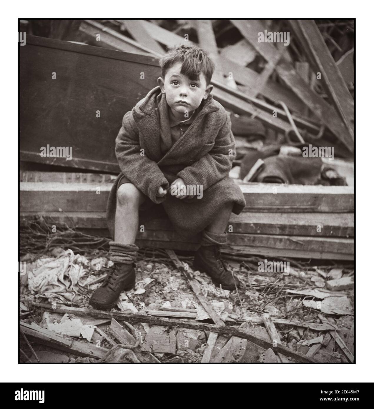 1940’s Nazi London Blitz Bombing Archive Boy 5-9 years seated in wreckage of home after a bombing raid of London during Nazi Blitz terror bombing raid World War II] Frissell, Toni, 1907-1988, photographer [1945 Jan.] World War, 1939-1945--Destruction & pillage--England--London--1940-1950 War damage--England--London--1940-1950 Boys--England--London--1940-1950 Stock Photo