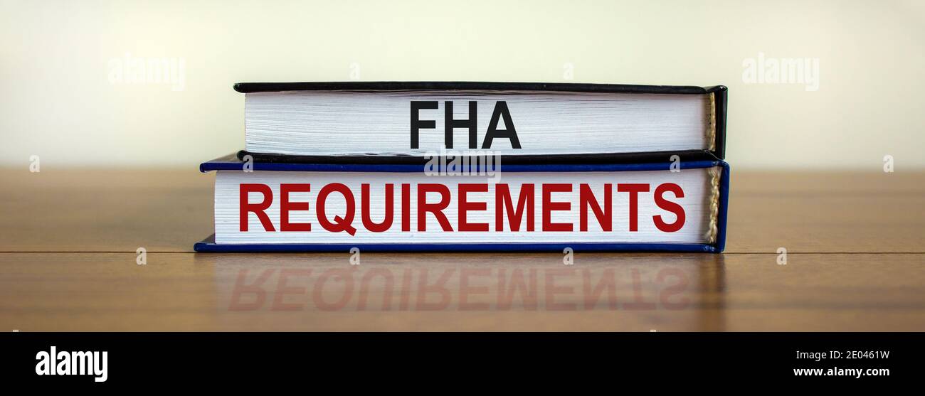 FHA requirements symbol. Books with words 'FHA requirements' on beautiful wooden table. White background. Business and FHA - federal housing administr Stock Photo