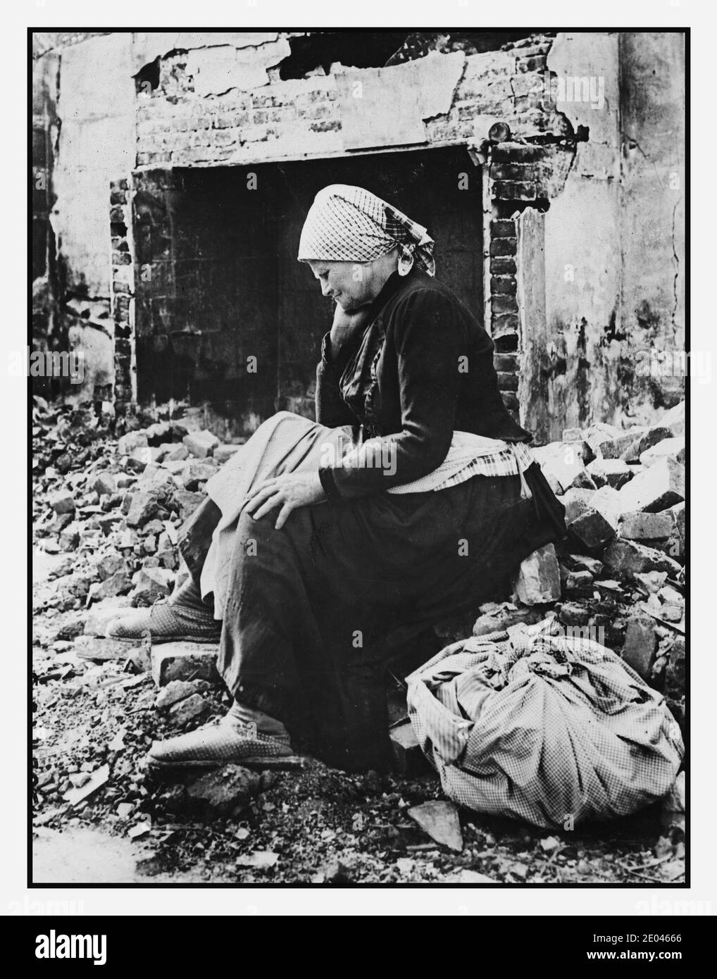 WW1 France German retreat from her district, French woman returns to find her home a heap of ruins elderly homeless French woman, full-length portrait, facing left, seated on the stone rubble of what once was her home in the Somme region of France; also shows a large fireplace in the background. 1917 July. First World War, 1914-1918--Destruction & pillage--France--Somme WW1  War damage--France--Somme--1910-1920 -  Debris--France--Somme--1910-1920 -  Older people--France--Somme--1910-1920 -  Women--Clothing & dress--France--Somme--1910-1920 -  Despair--1910-1920 - Stock Photo