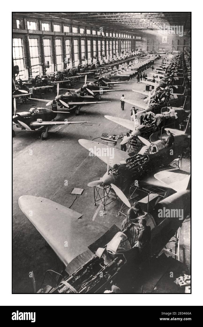 1942 Soviet WW2 Fighter Airplane Production Line “Yak' fighter planes, for the Soviet Russian air force, on the assembly lines at a Soviet factory somewhere in the USSR, March 1942 interior view of a factory with Russian fighter planes being manufactured on an assembly line. 1942. World War II Second World War Soviet USSR Russia -  Fighter planes--Russian--1940-1950 -  Factories--Soviet Union--1940-1950 -  Assembly-line methods--Soviet Union--1940-1950 -  World War, 1939-1945--Equipment & supplies--Russian -  World War, 1939-1945--Air operations--Russian Stock Photo