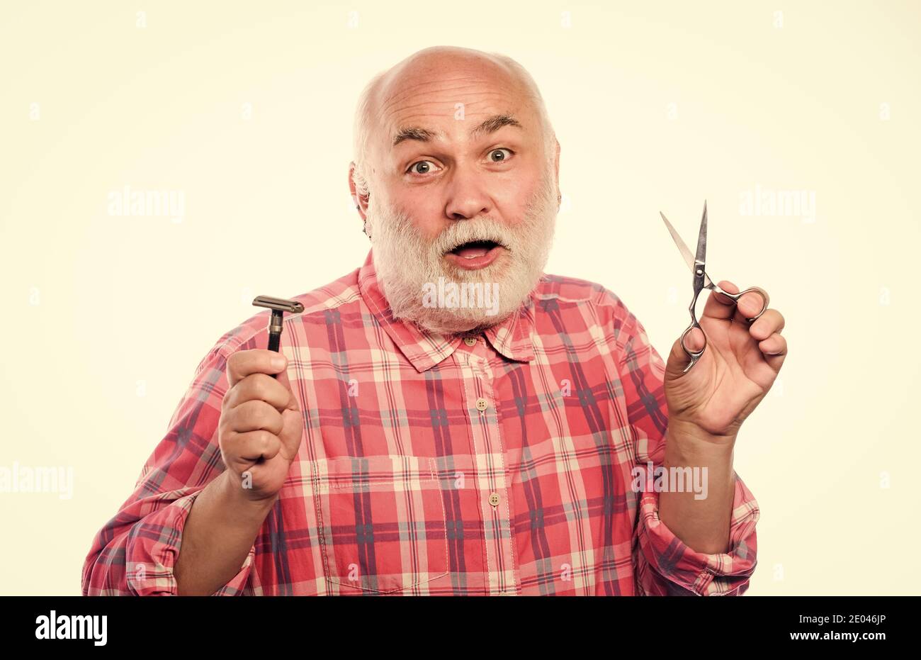 Pick perfect length and shape of beard. Mature man barber hold scissors