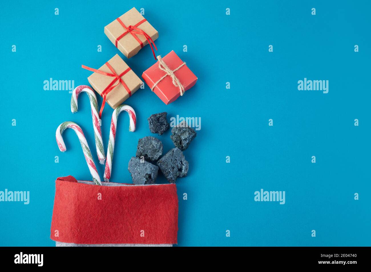 Sweet coal and candy with gift box in sock. Typical things for Epiphany day or Dia da Reyes Magos Stock Photo