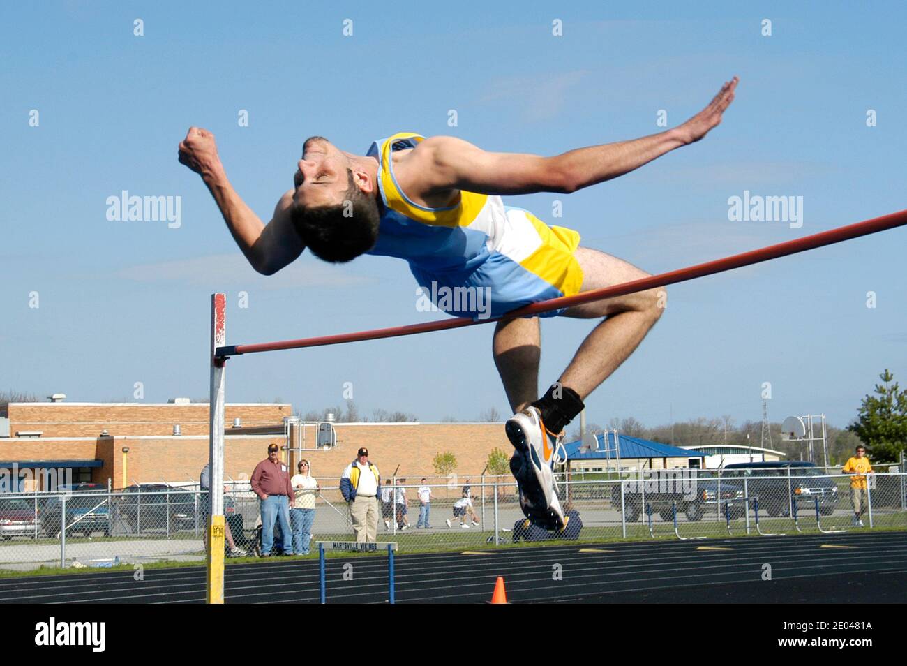 High School track and field event paticipant in the high Jump Stock