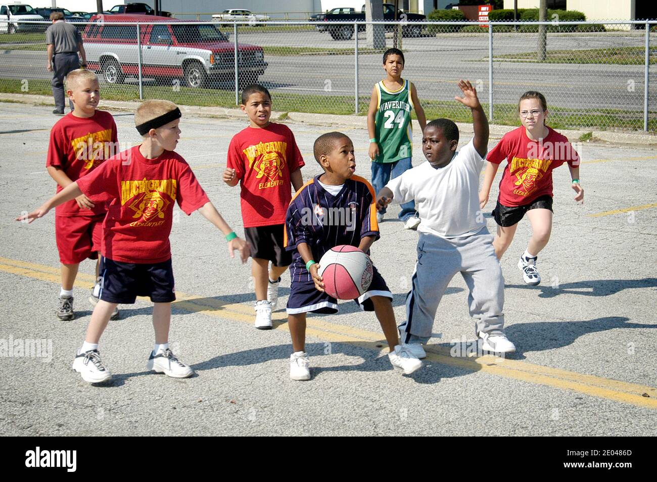 8 through 10 year old boys and girls play basketball outside in a city sponsored tournament Port Huron Michigan MI Stock Photo
