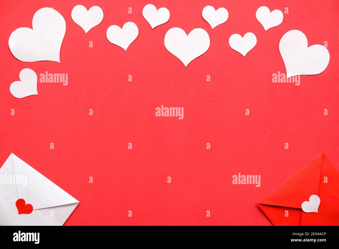 Background for Valentine's day. White and rat envelopes, white hearts on a red background. Stock Photo