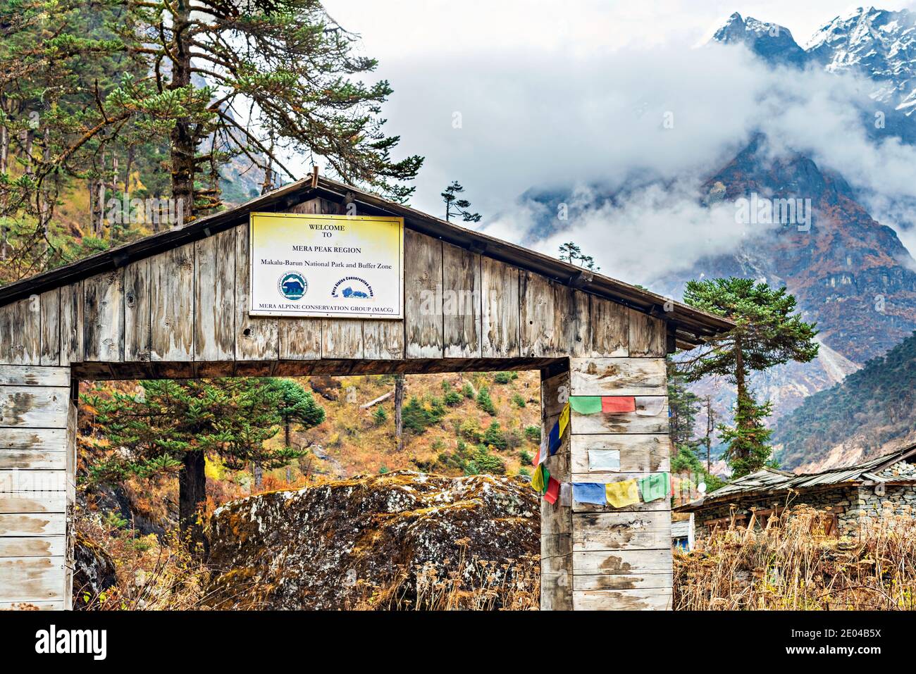 Kothe, Nepal - Nov 29, 2019: View at welcome sign and the Himalayan mountains landscape at Kothe, it is on trekking route to Mera peak in Nepal. Stock Photo