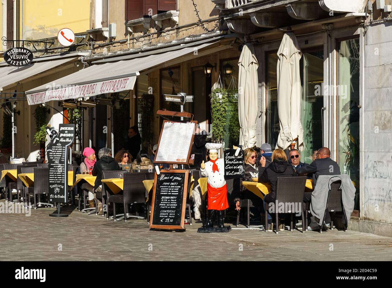 People sitting outside restaurant in the sestiere of Cannaregio, Venice, Italy Stock Photo