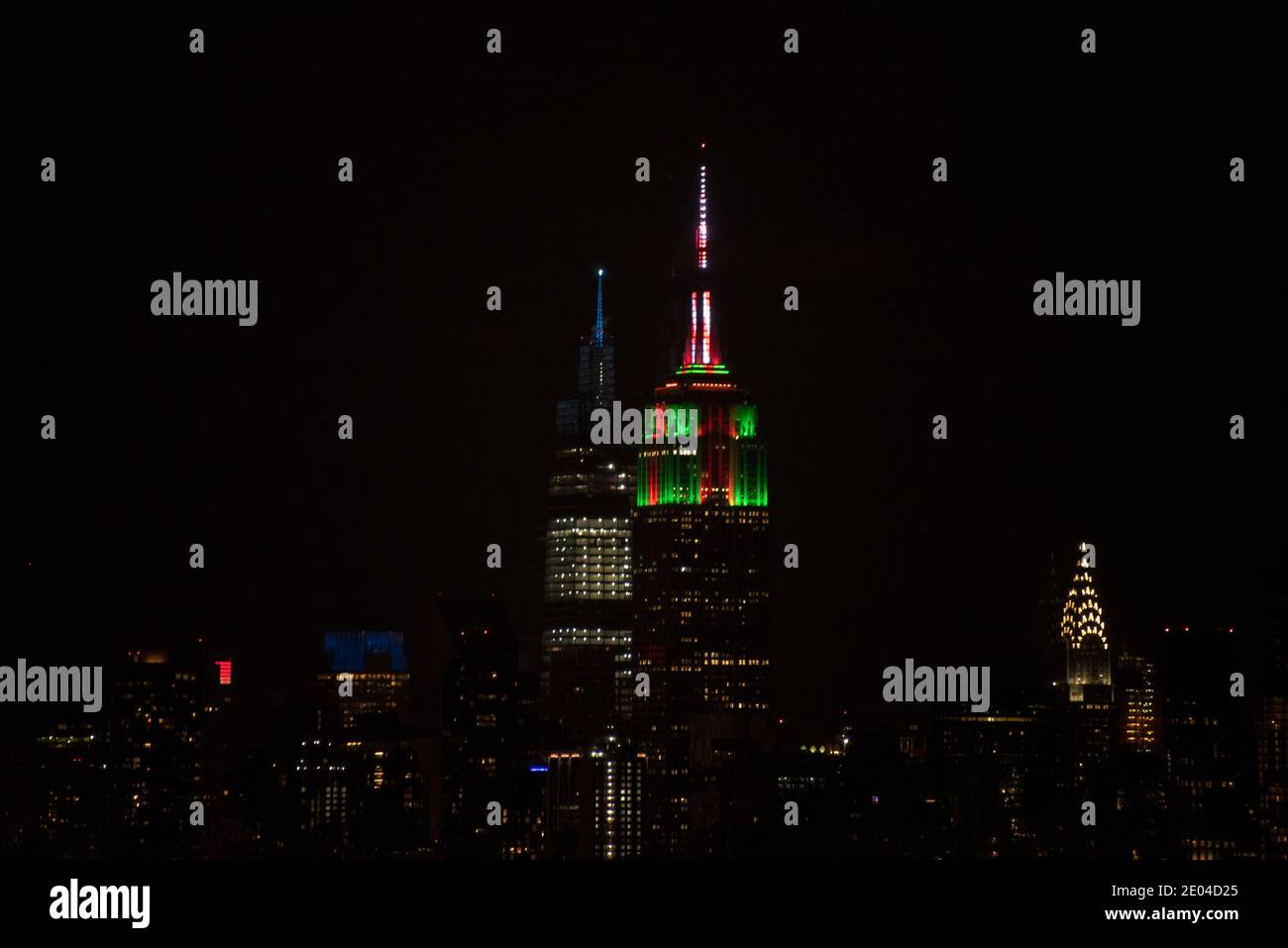Midtown Manhattan at night and Empire State Building in Christmas color for the holiday season. Stock Photo