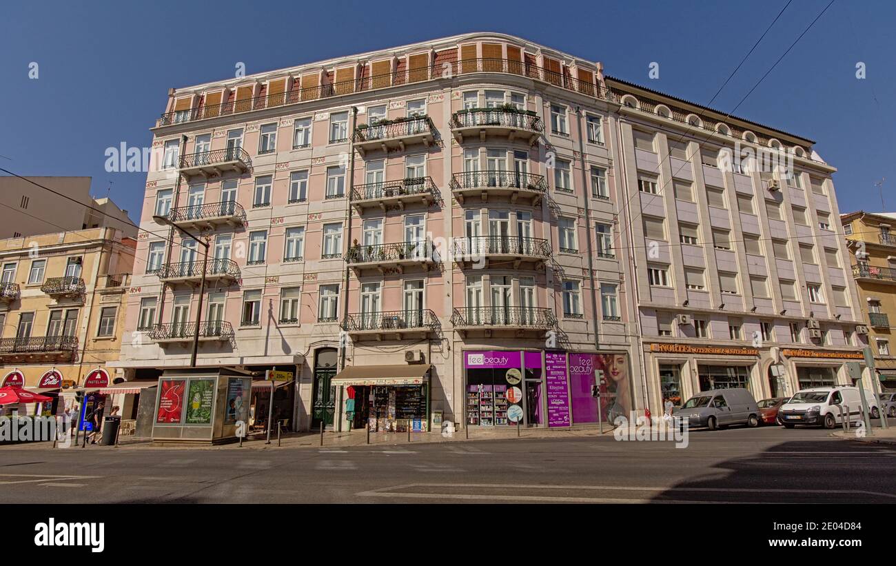 Facade of a typical apartment building in pastel colors in Lisbon ...