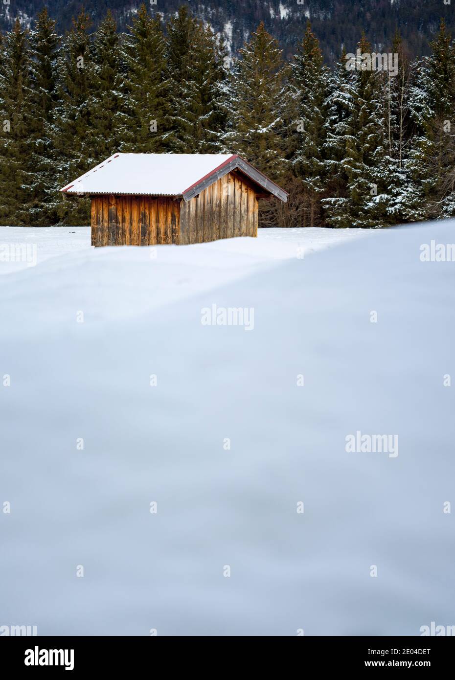 wooden hut in snowy winter forest Stock Photo