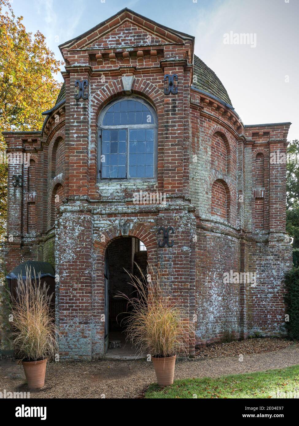 Red brick Tudor summerhouse in the garden of The Vyne, featuring one of the earliest neo-classical domes in England. Stock Photo
