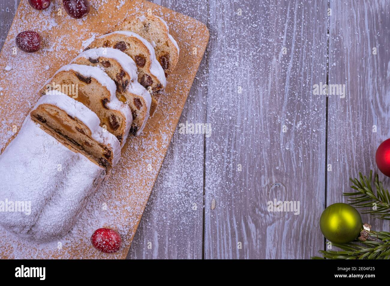 Christmas marzipan stollen cake with icing sugar, marzipan and raisins. Stock Photo