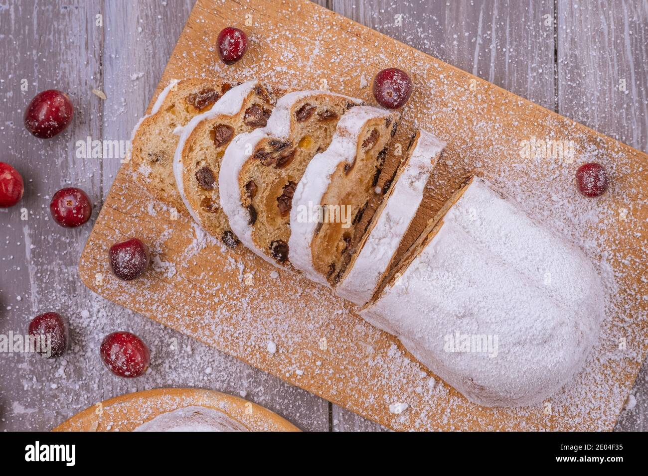 Christmas marzipan stollen cake with icing sugar, marzipan and raisins. Stock Photo