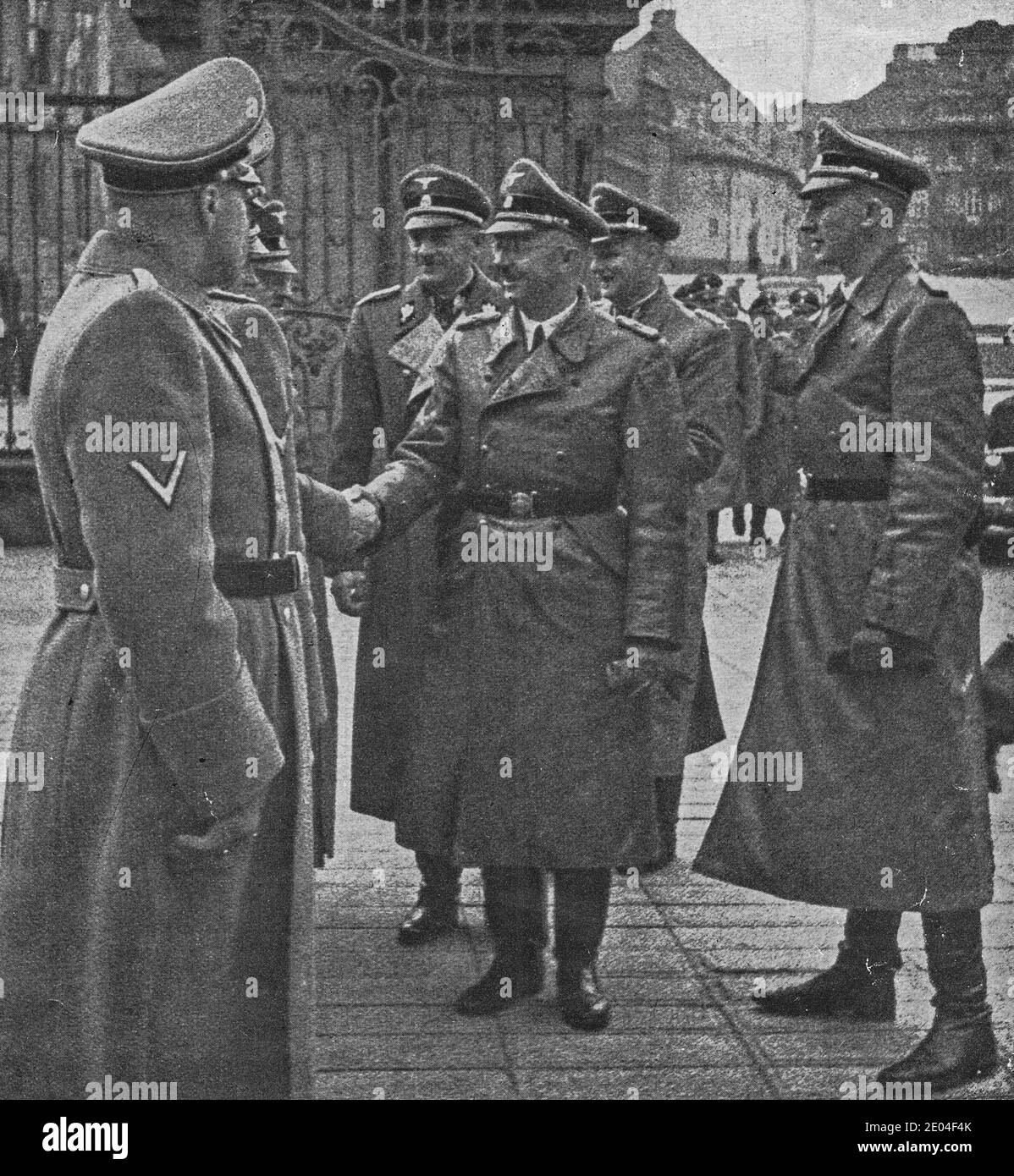 PRAGUE, PROTECTORATE OF BOHEMIA AND MORAVIA - OCTOBER 1941: Reichsfuhrer Heinrich Himmler greets others nazis at Prague castle. On the right is Reinha Stock Photo
