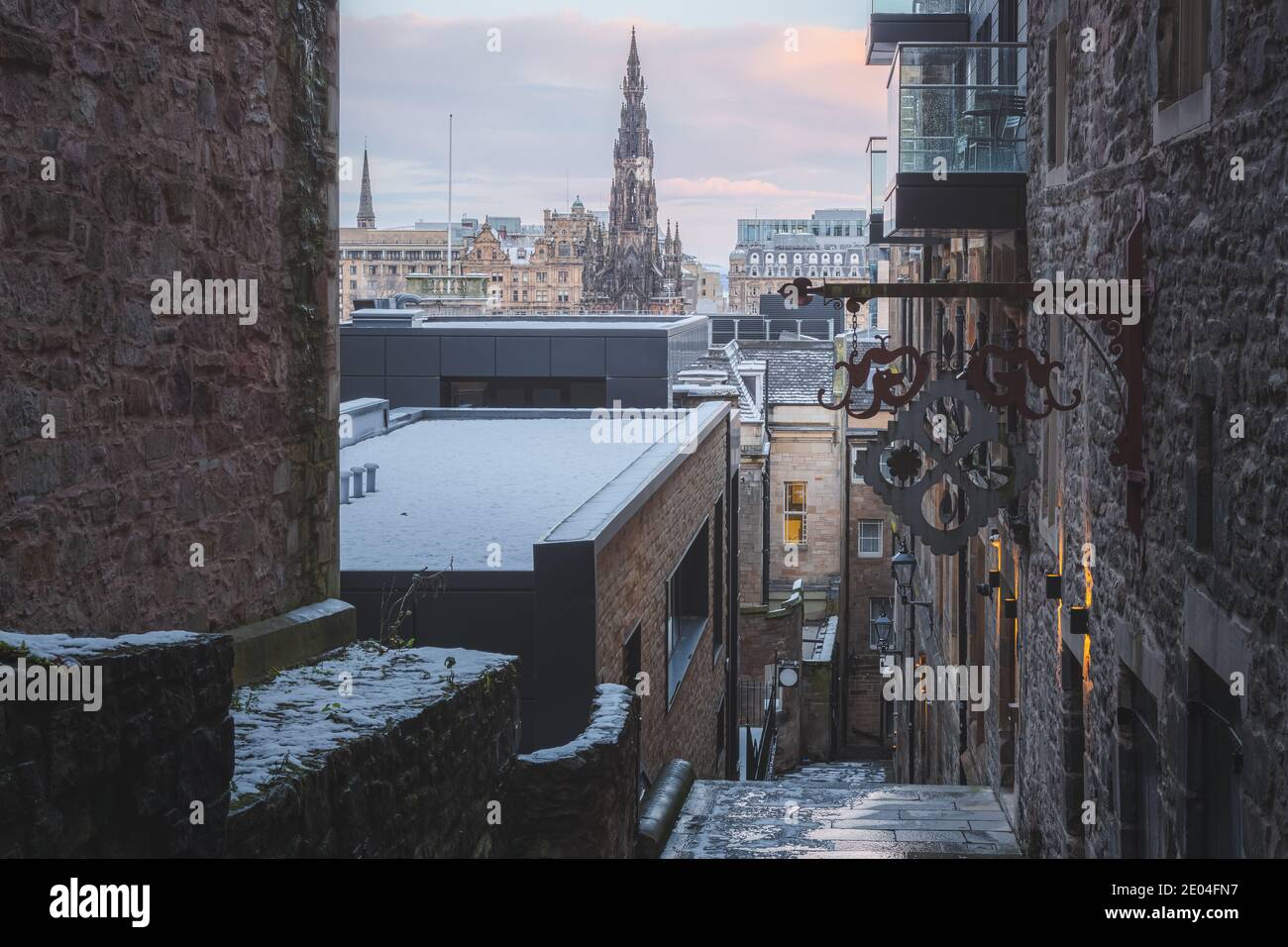 A view from Advocate's Close out to Princes Street in Edinburgh and the Scott Monument on a December morning after an overnight snowfall. Stock Photo