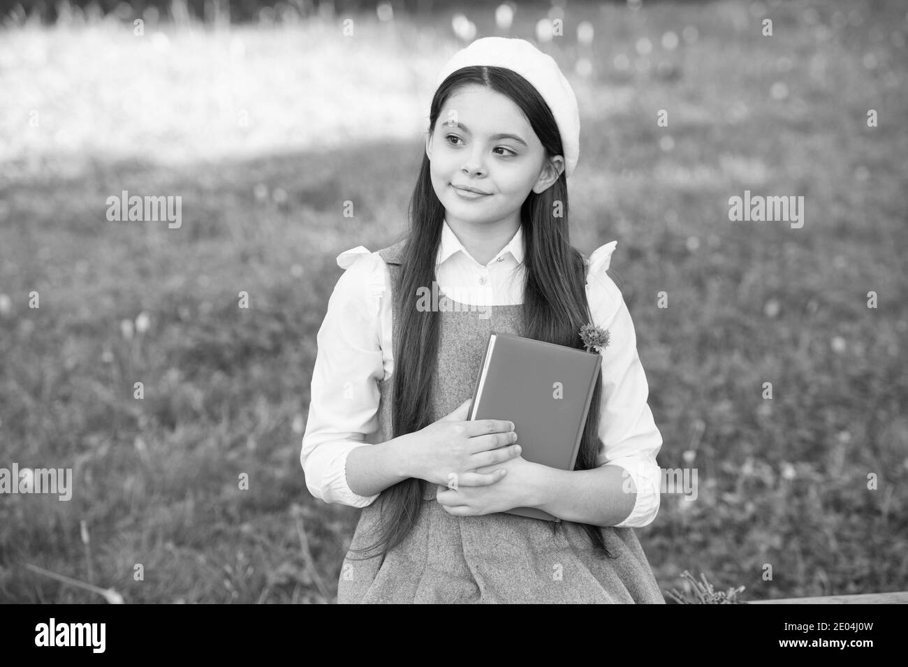 Be mindful. Thoughtful child think sitting on bench outdoors. Little girl back to school. Learning and thinking skills. Brainwork. School and education. Think positive. Think and believe. First think. Stock Photo