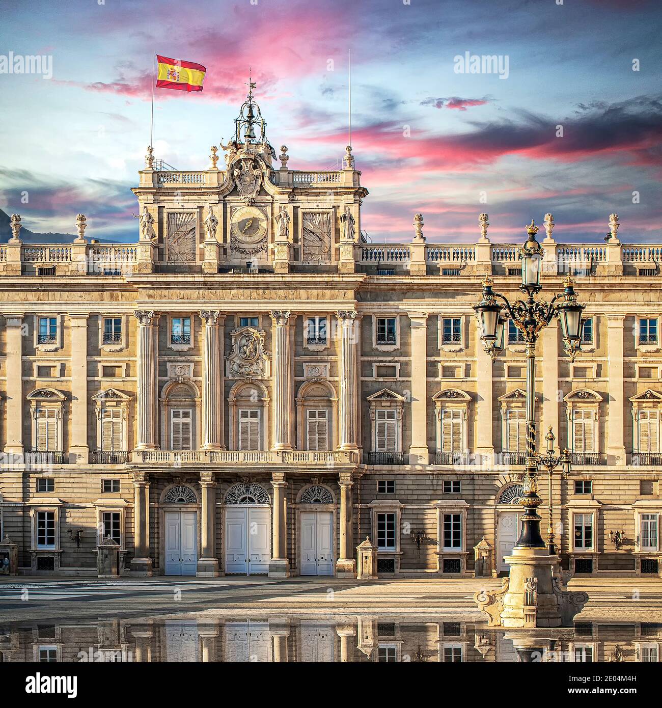 Royal Palace of Madrid, Spain at sunset with pink clouds. Stock Photo