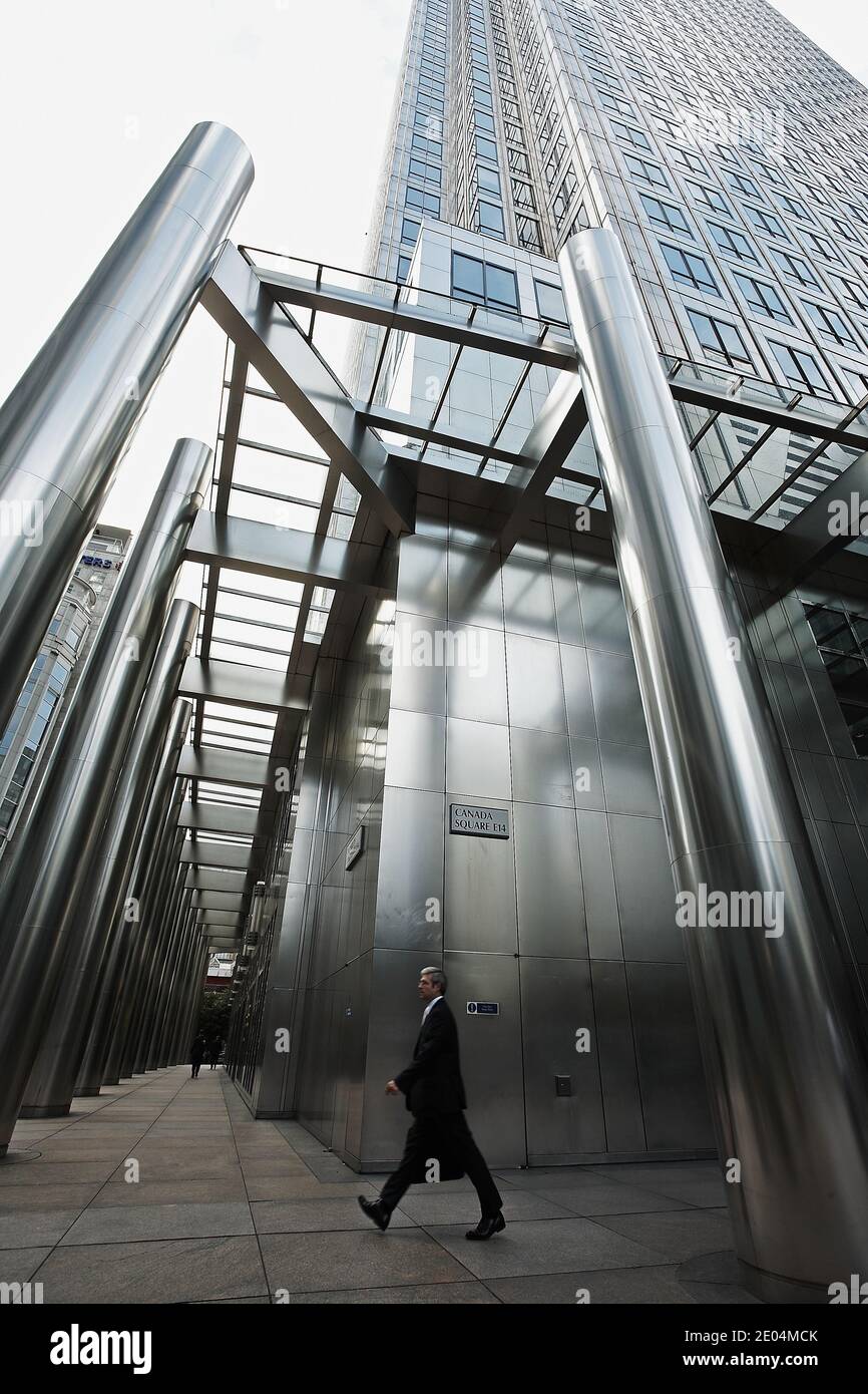 A city worker on the street outside Canary Wharf . Canary Wharf is a major financial district in the city. Stock Photo