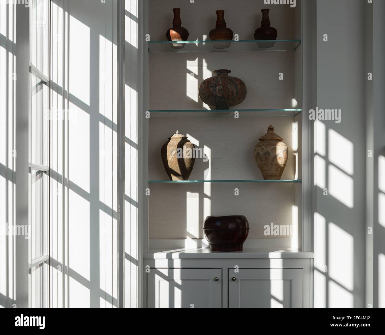 Light from window streaming on antique pottery collection Stock Photo