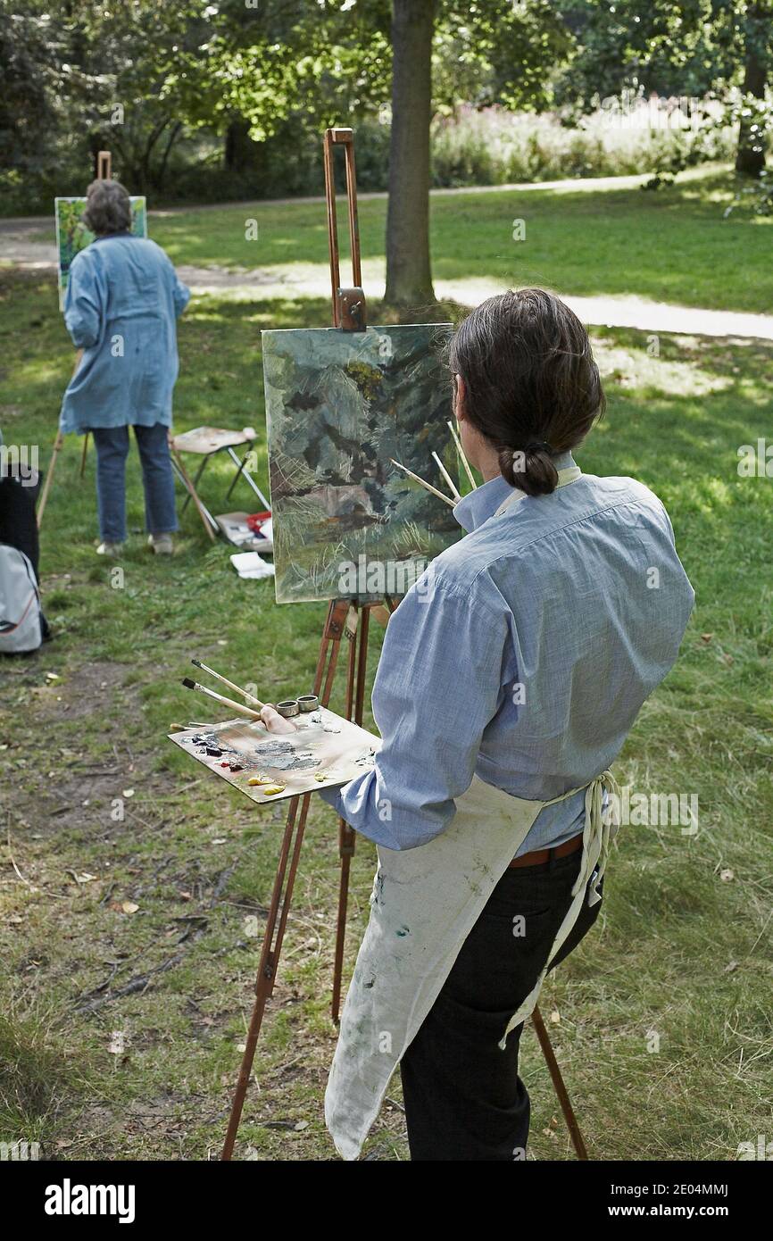 GREAT BRITAIN / London /Two Painter painting outdoors in Hampstead Heath (locally known as 'The Heath') is a public open space in the north of London. Stock Photo