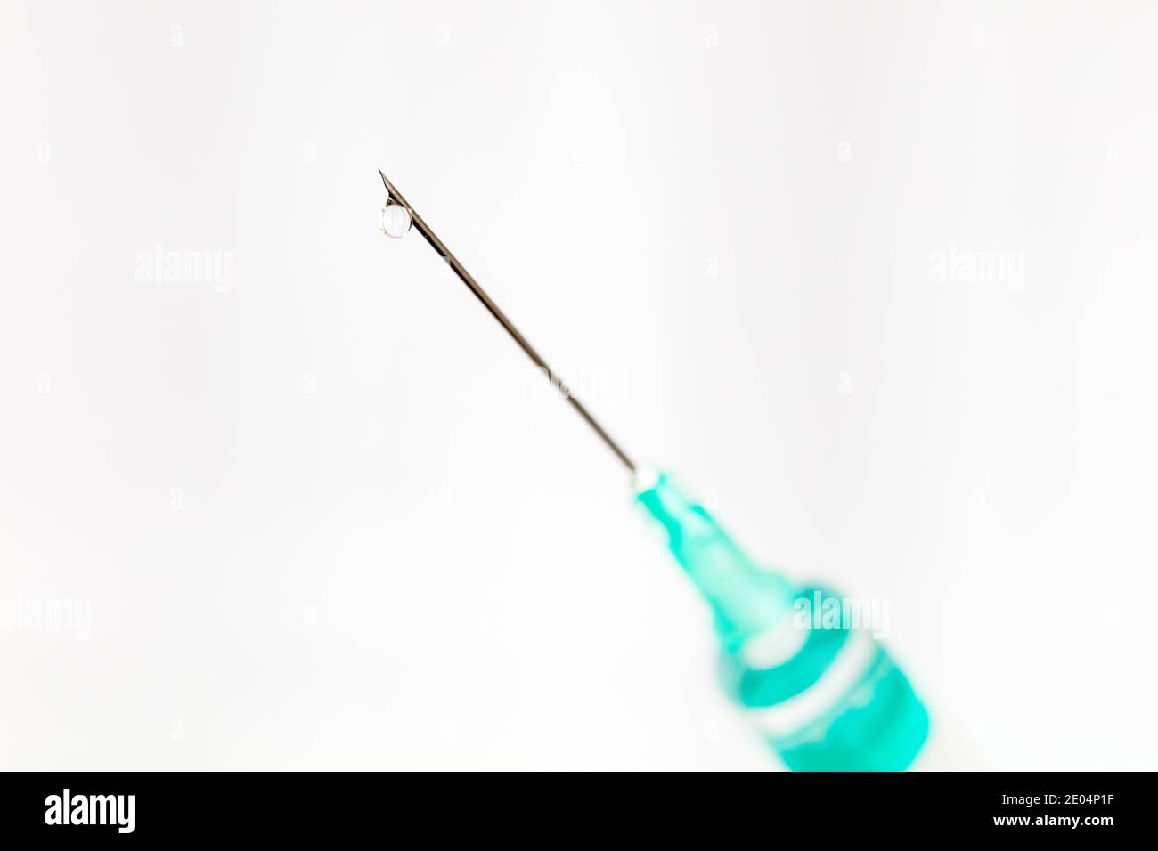 Needle with drop isolated on white background, macro Stock Photo