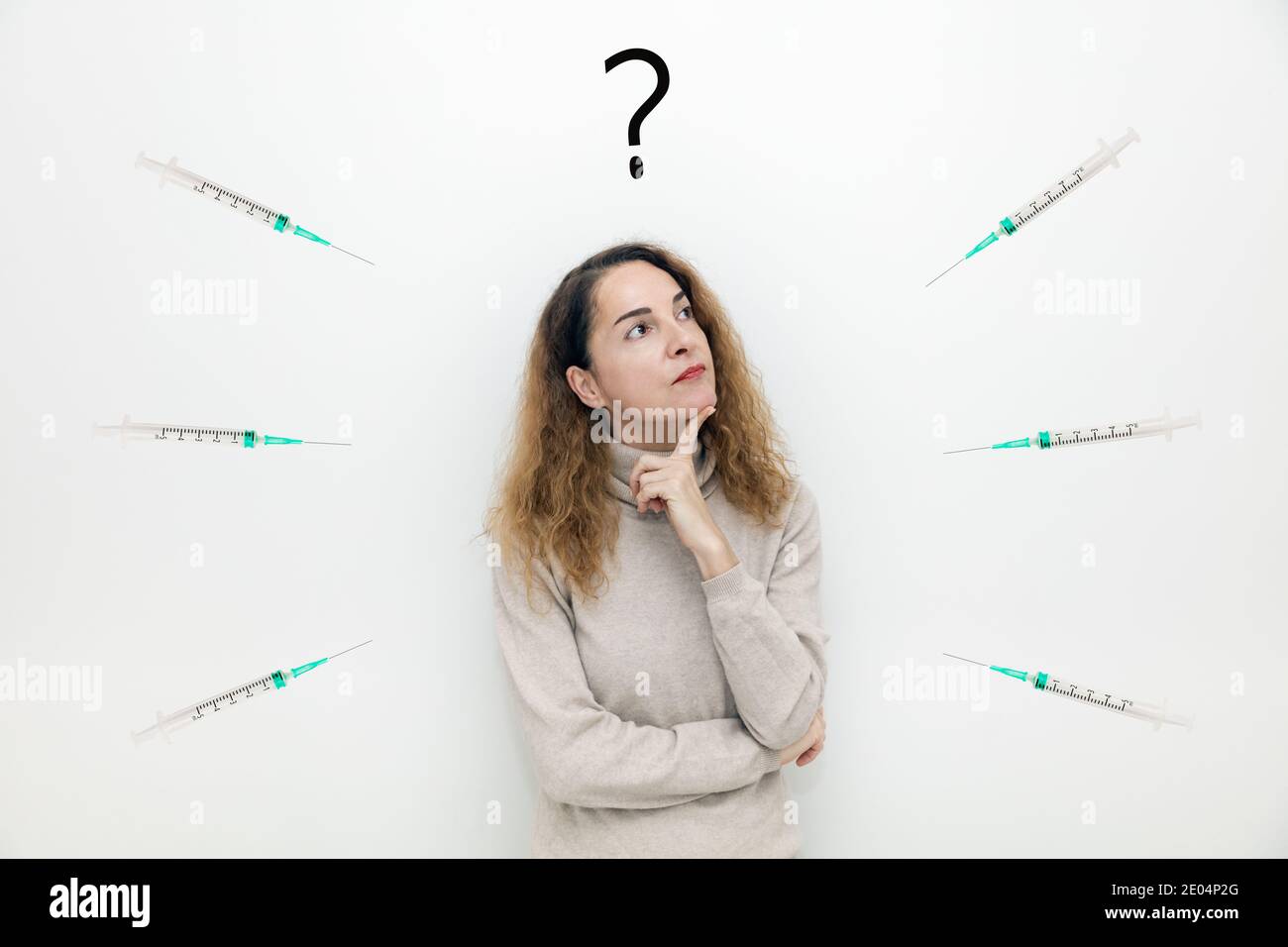 A woman with syringes around her thinking with serious face about question and doubts. Stock Photo