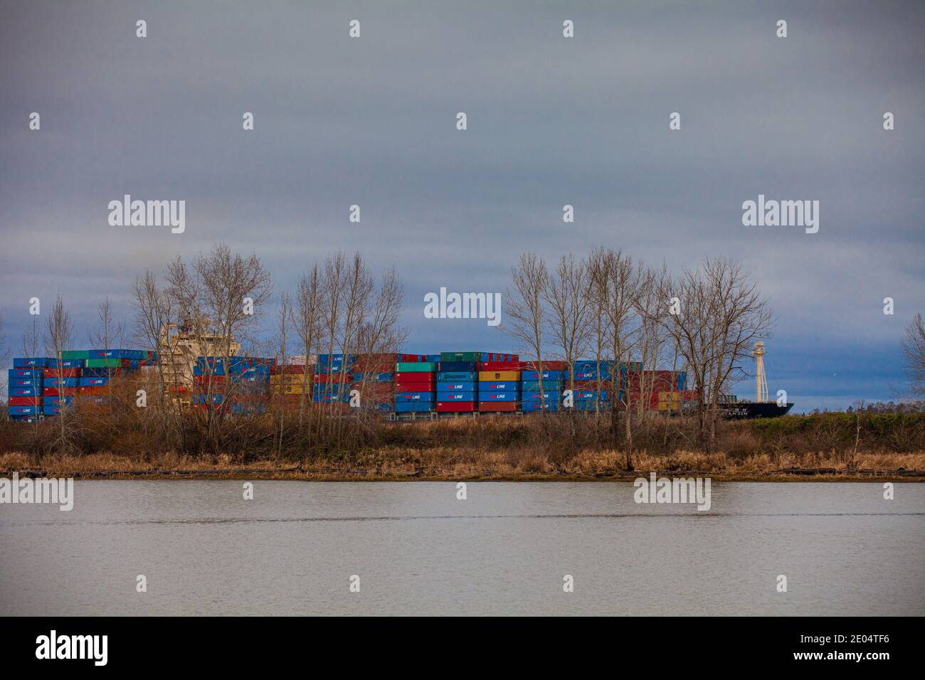 Heavily loaded container ship exiting the Fraser River system south of