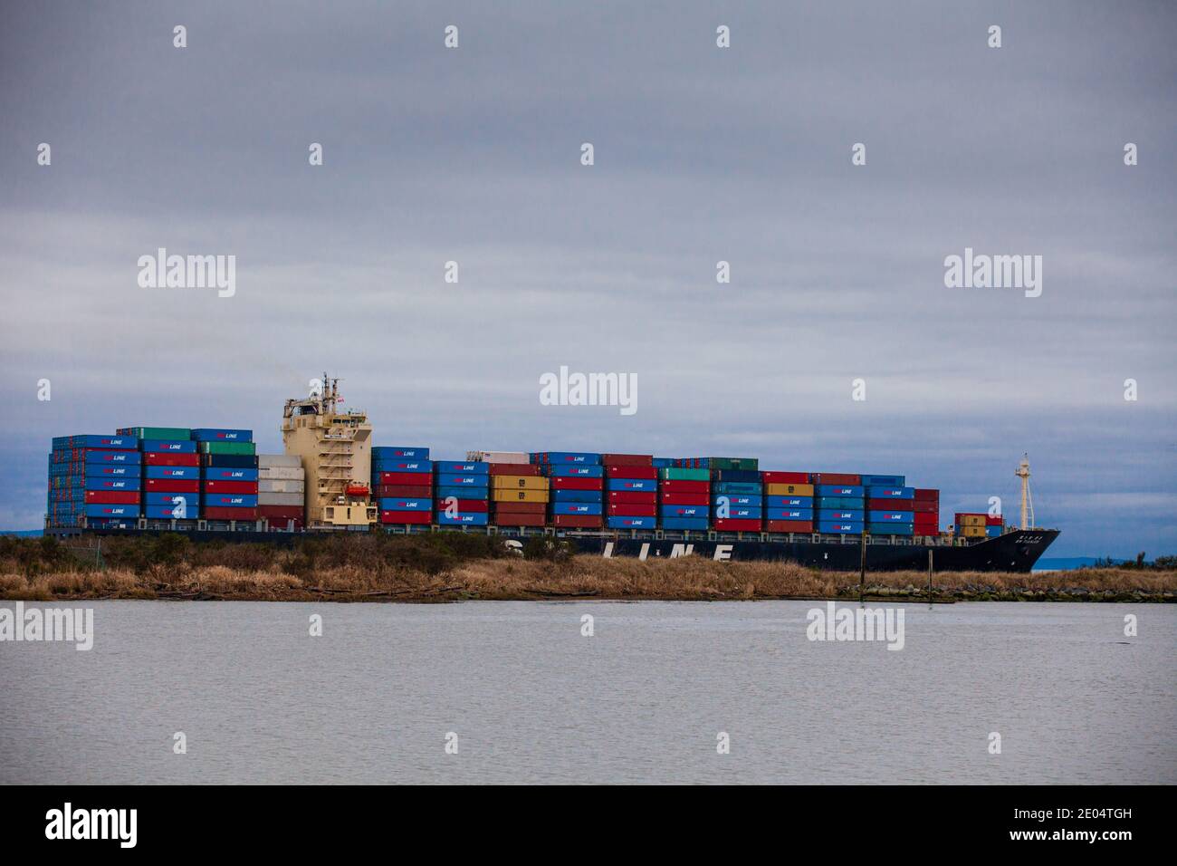 Heavily loaded container ship exiting the Fraser River system south of