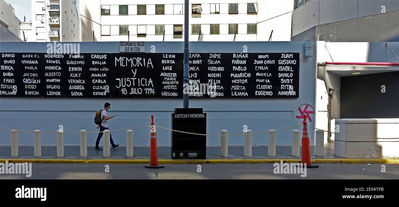 A man walks past the a board listing the names of the 85 people killed in a 1994 terrorist attack on the AMIA Jewish Centre in Buenos Aires, Argentina Stock Photo