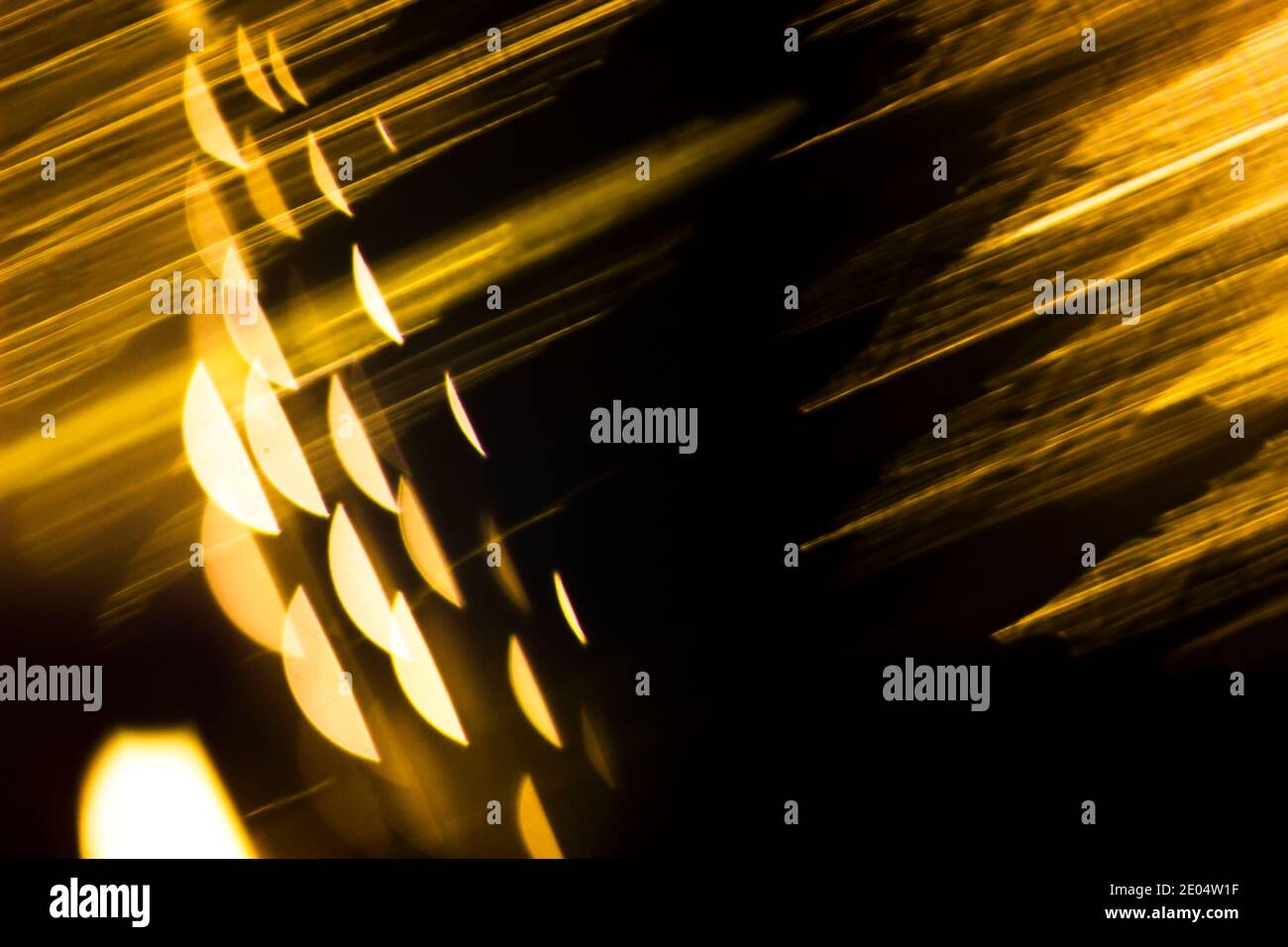 Abstract illuminating golden backdround with linear and spherical shapes. Isolated black background for text entry Stock Photo
