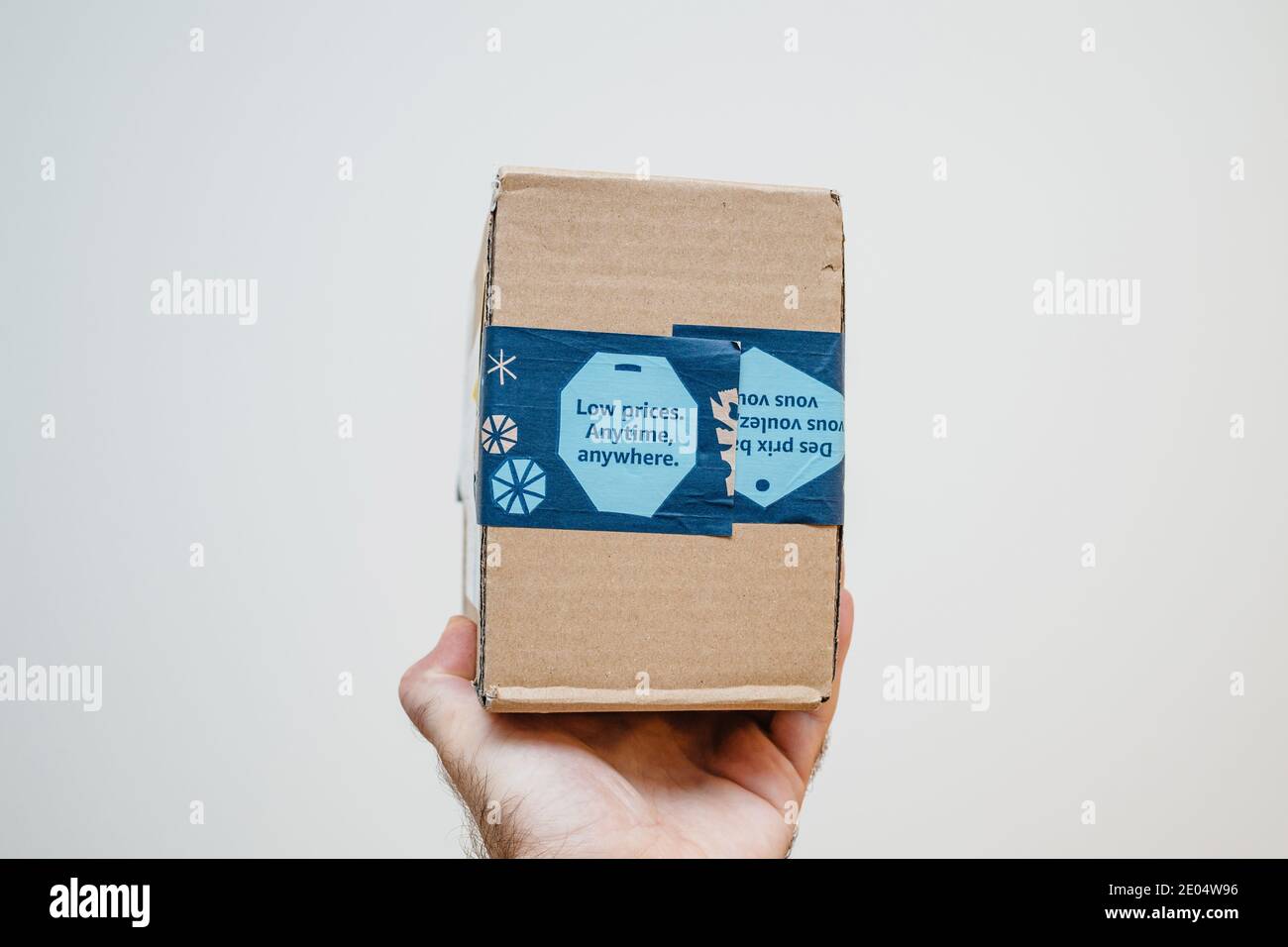 Paris, France - Dec 12, 2020: POV male hand holding parcel package from  Amazon Prime with Low Price Anytime, Anywhere advertising on the package -  isolated on white Stock Photo - Alamy