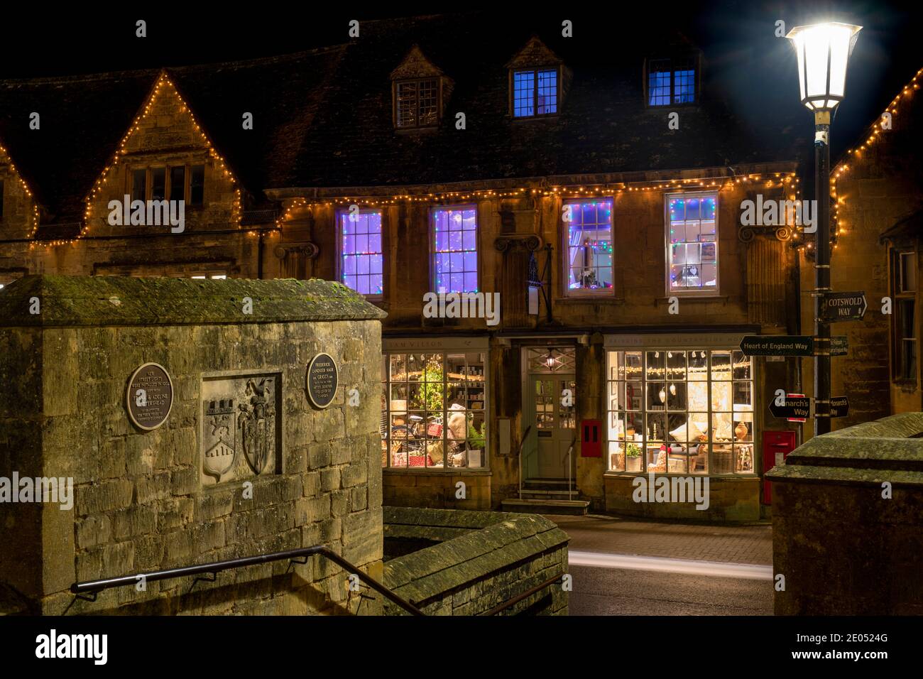 Chipping Campden high street shop with christmas lights and decorations at dusk. Chipping Campden, Cotswolds, Gloucestershire, England Stock Photo