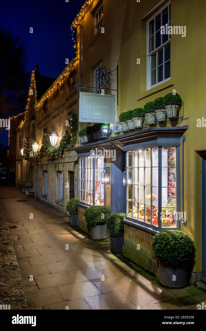 The Covent Garden Academy of Flowers along the high street with christmas lights at dawn. Chipping Campden, Cotswolds, Gloucestershire, England Stock Photo