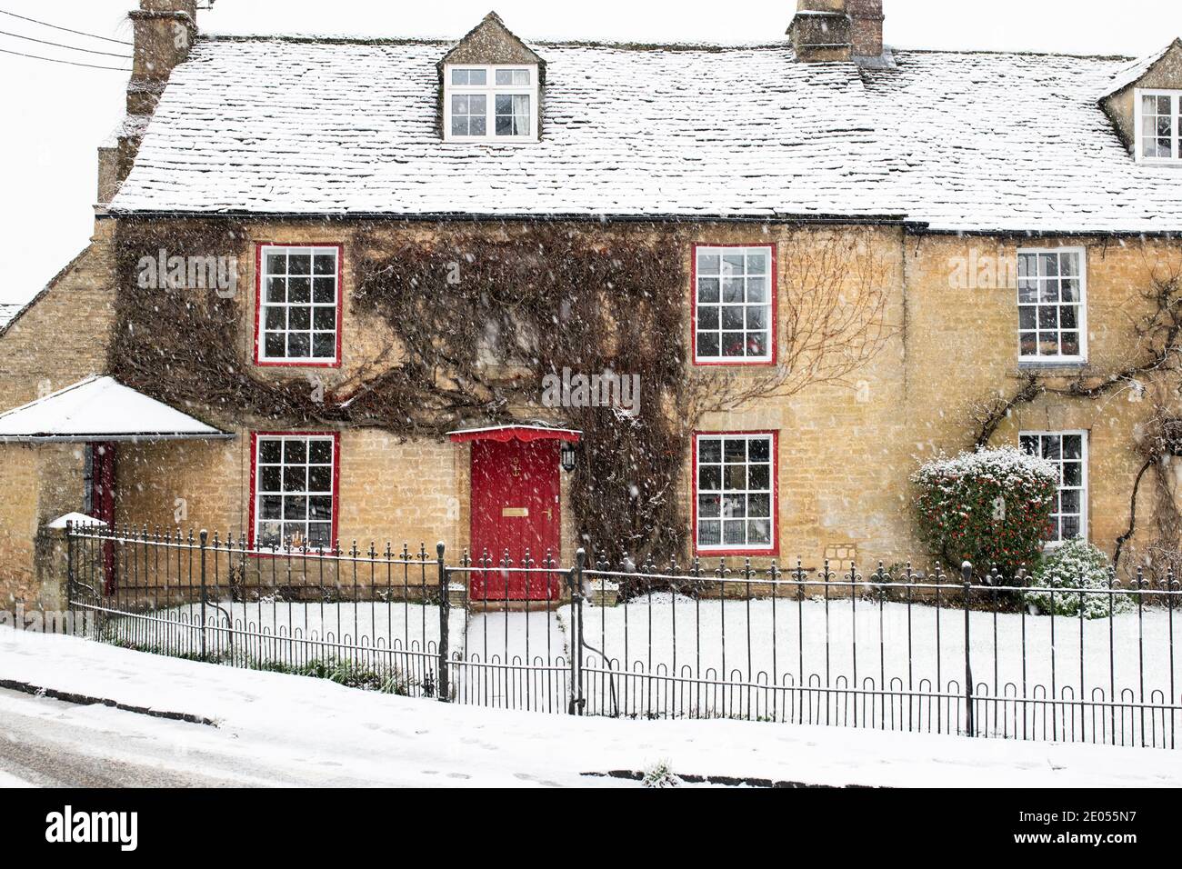 Cotswold stone cottage in the snow at christmas. Shipton Under Wychwood
