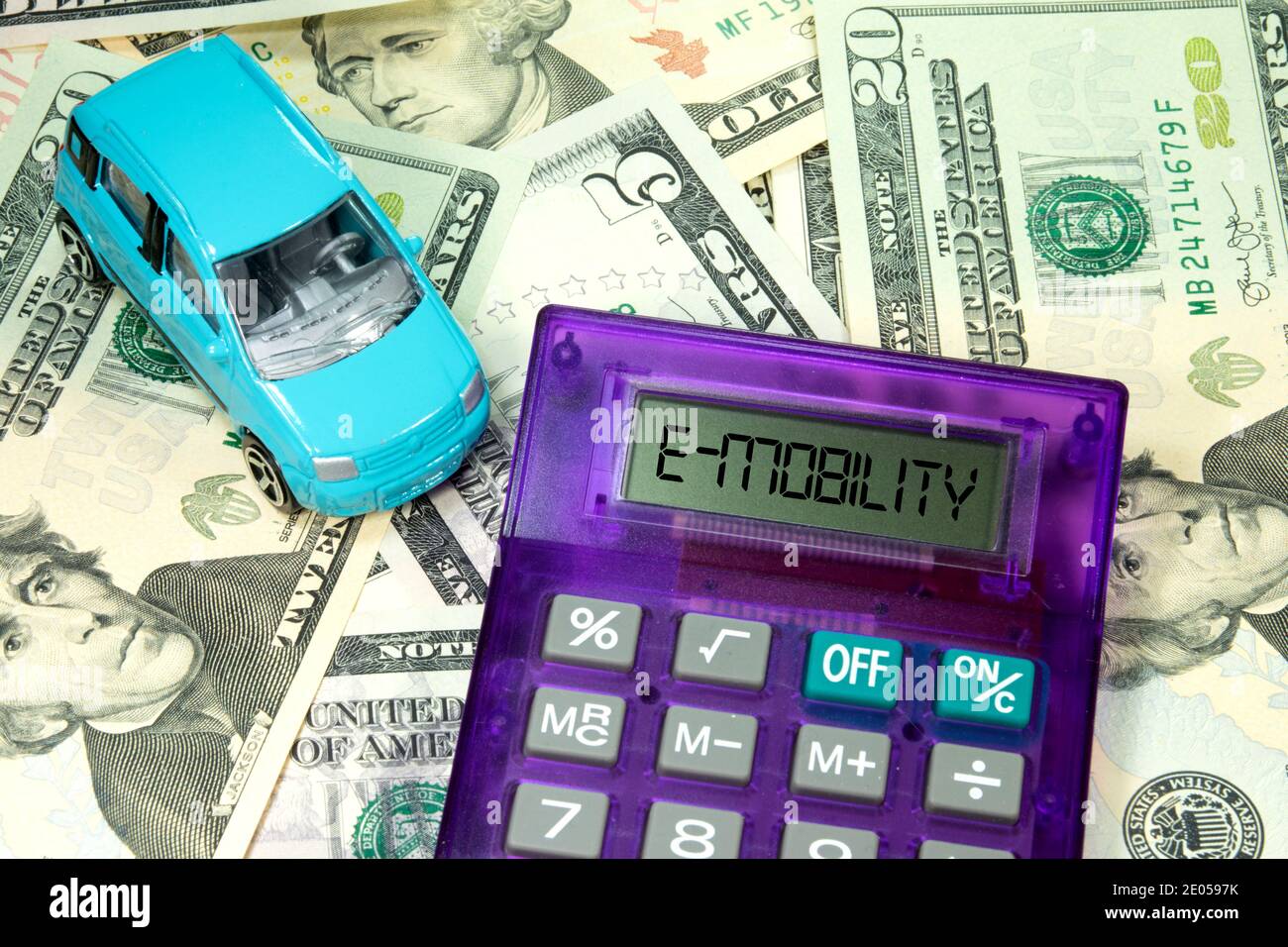 Car, dollar bills and the cost of e-mobility Stock Photo