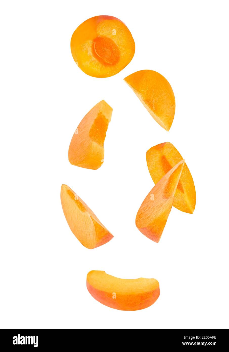 Falling sliced fresh apricot fruit isolated on white Stock Photo