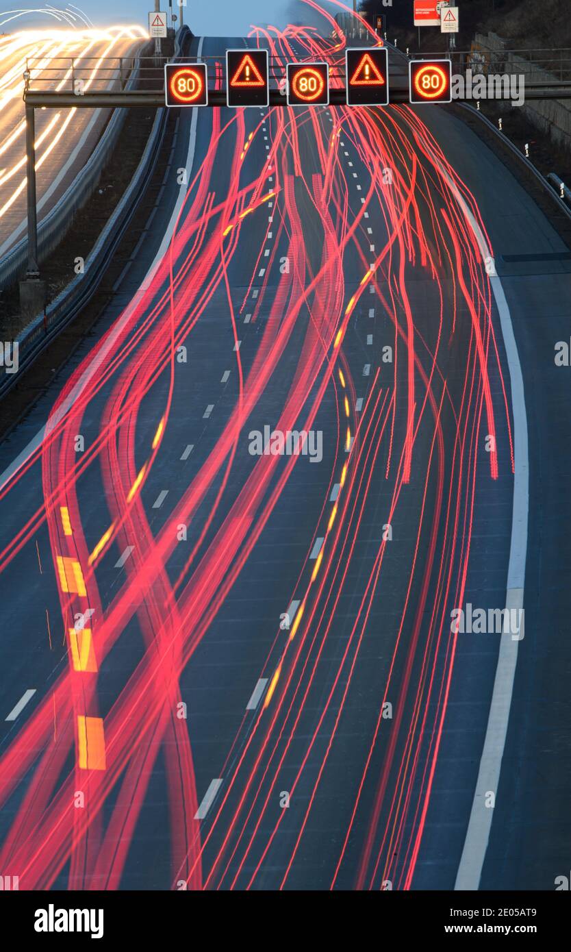 Dresden, Germany. 30th Dec, 2020. The headlights of passing vehicles draw 4 light trails on the highway in the morning. (Shot with long exposure) Credit: Robert Michael/dpa-Zentralbild/dpa/Alamy Live News Stock Photo