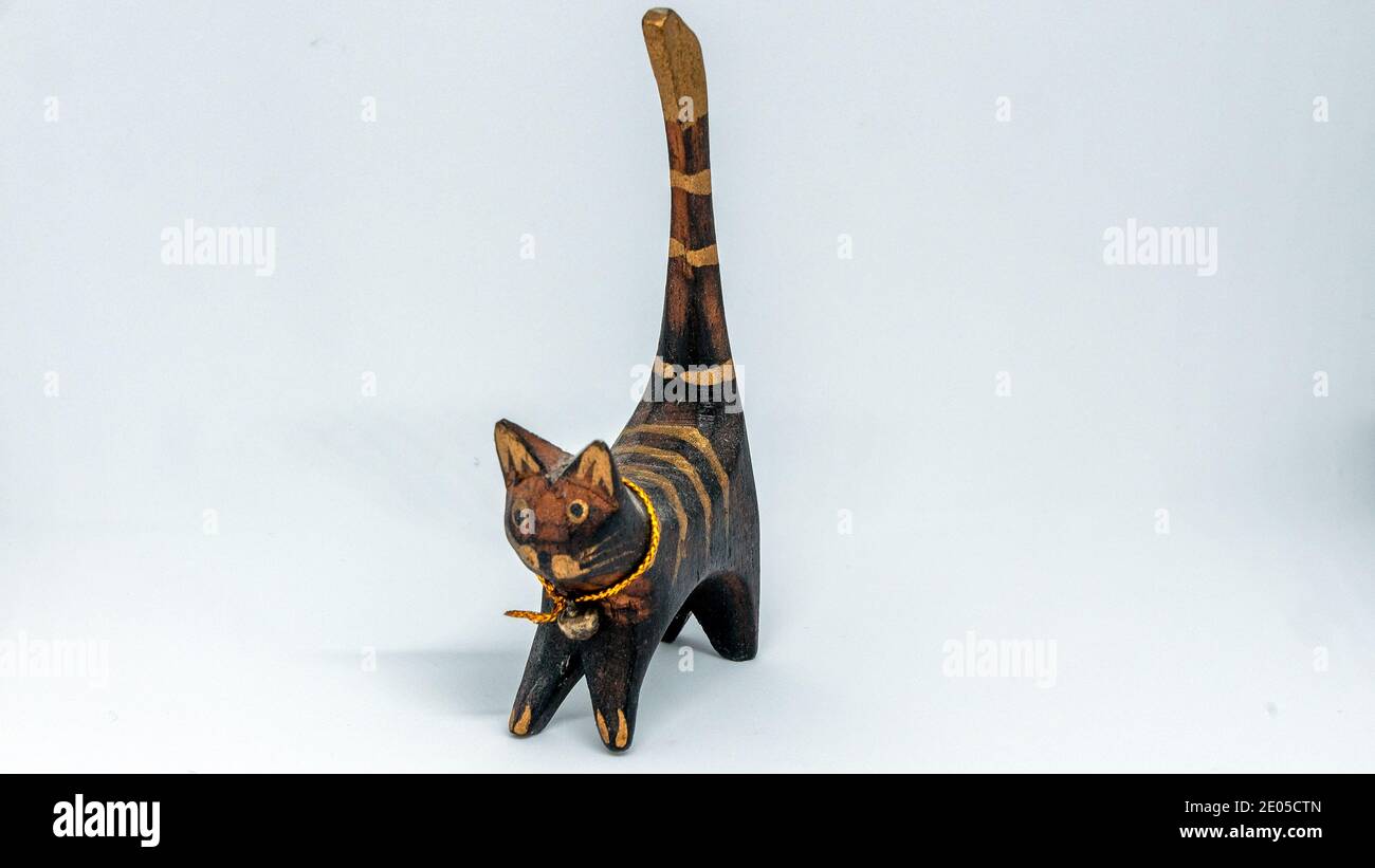 Figure of a striped wooden cat close up Stock Photo