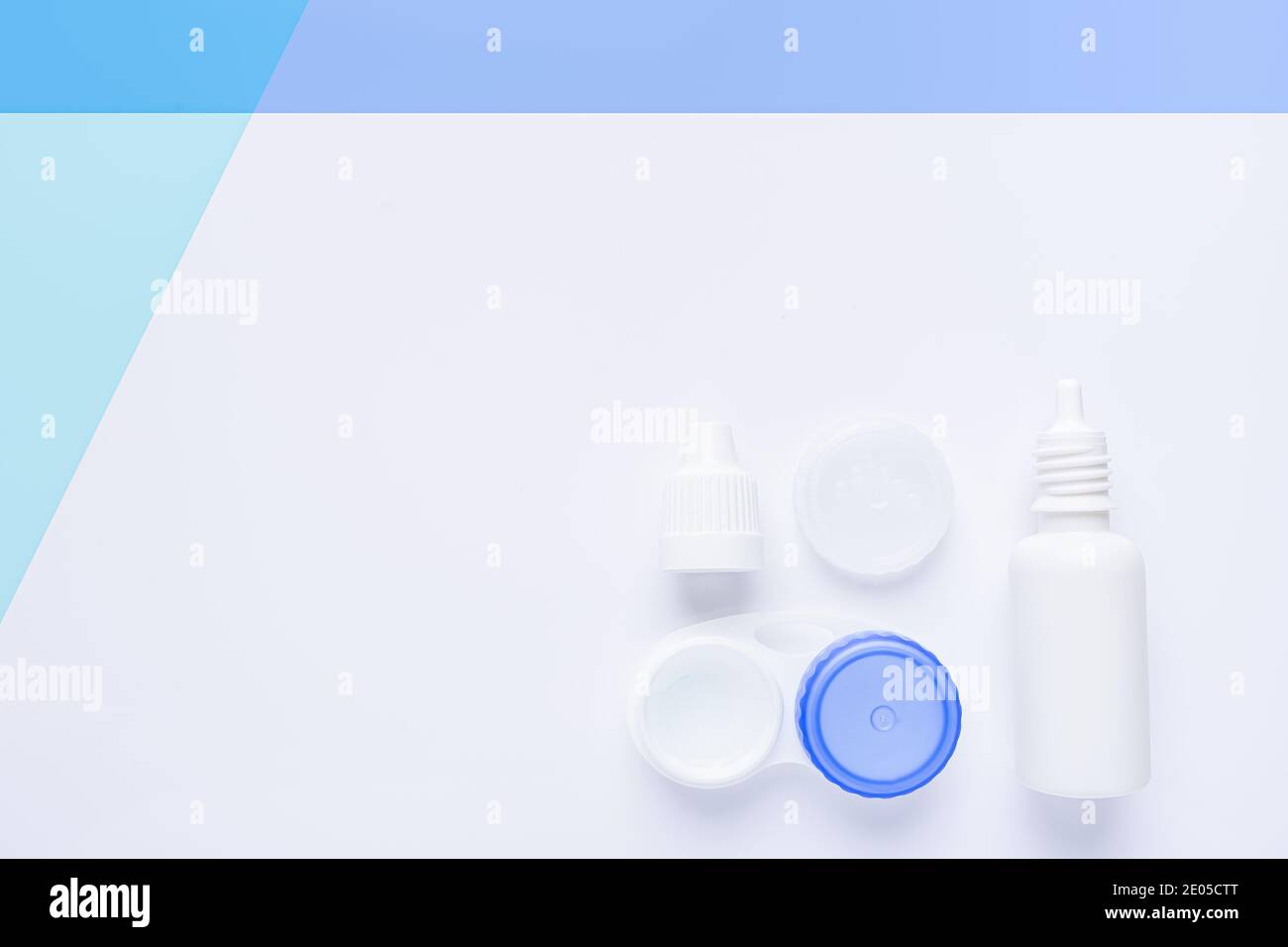 contact lens case on white and blue background, with copy space. Stock Photo