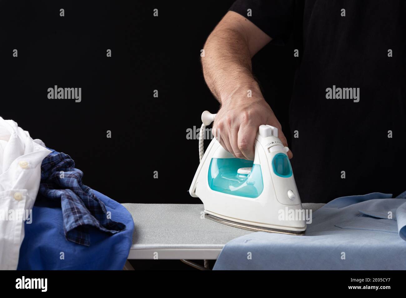 Woman Hand Ironing A Shirt, On Cloth Background Stock Photo