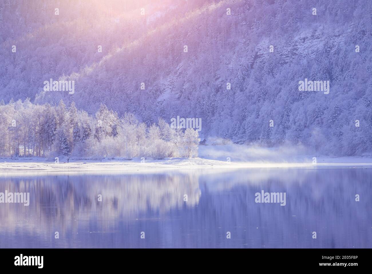 Idyllic winter landscape: Reflection lake, snowy trees and mountains Stock Photo