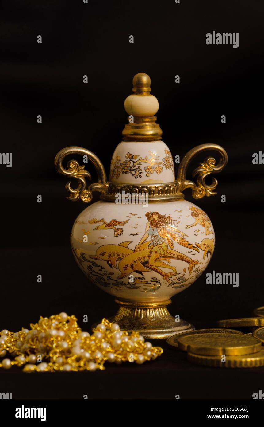 Vintage decorative small bottle of attar perfume or cologne on Black