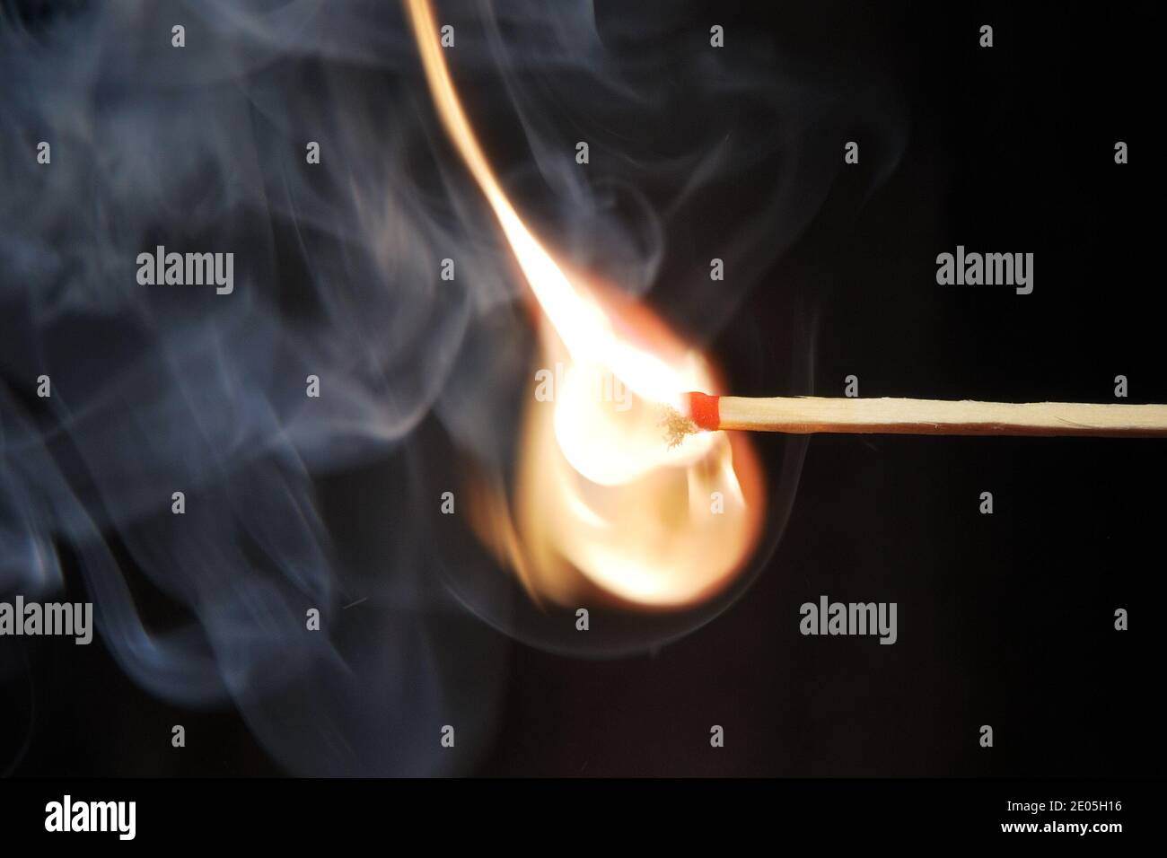 match ignited with a beautiful orange flame with black background Stock ...