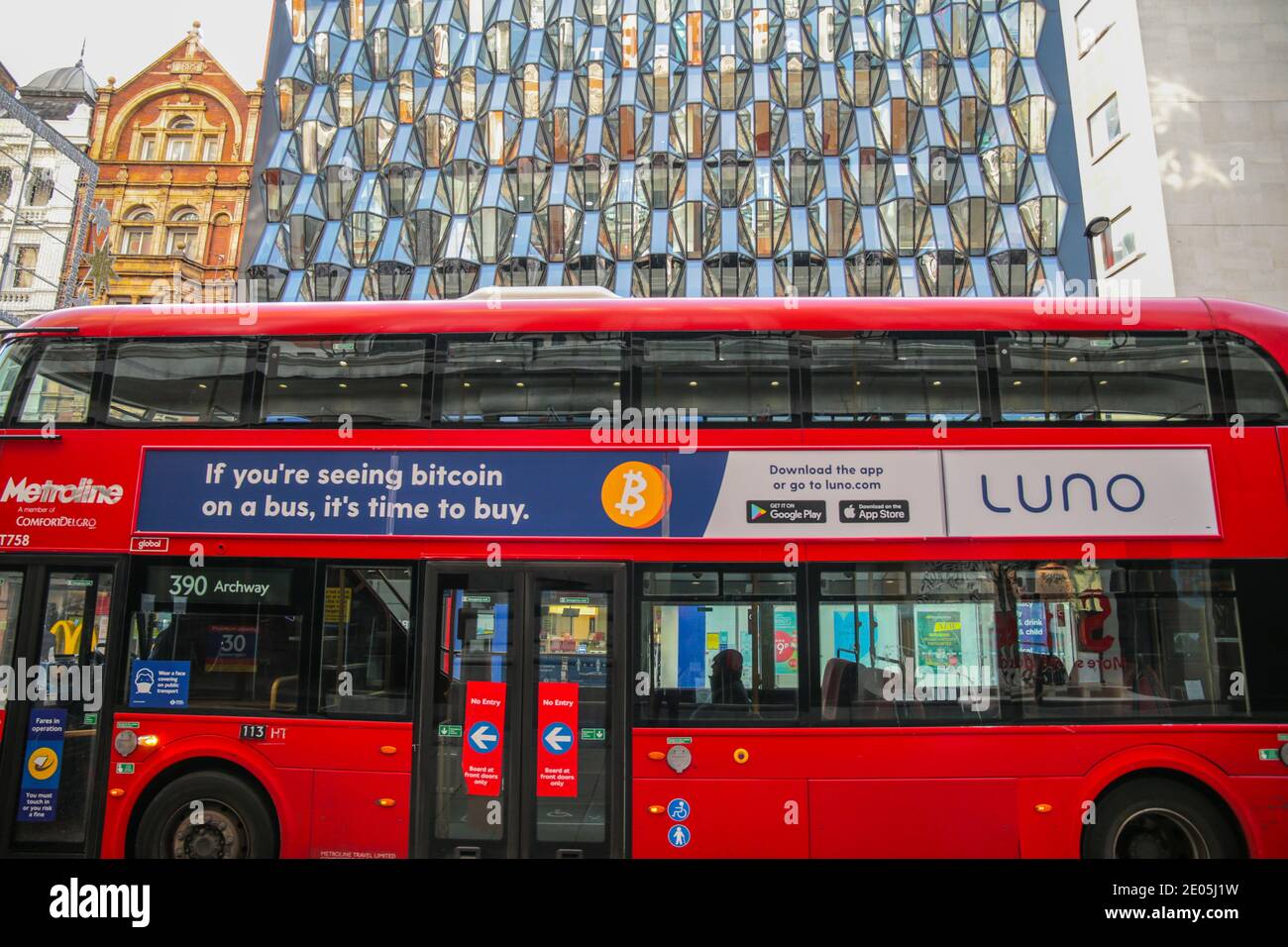 London UK 30 December 2020 A London bus passes by the beautiful abstract widow, that reflects